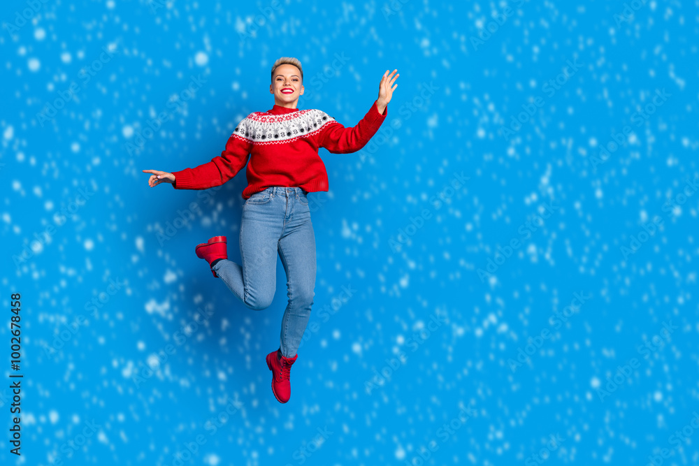 Full body photo of nice jumping air active woman wear red ornament sweatet celebrate winter season sale collection isoalated on blue color background Full body photo of nice jumping air active woman wear red ornament sweatet celebrate winter season sale collection isoalated on blue color background