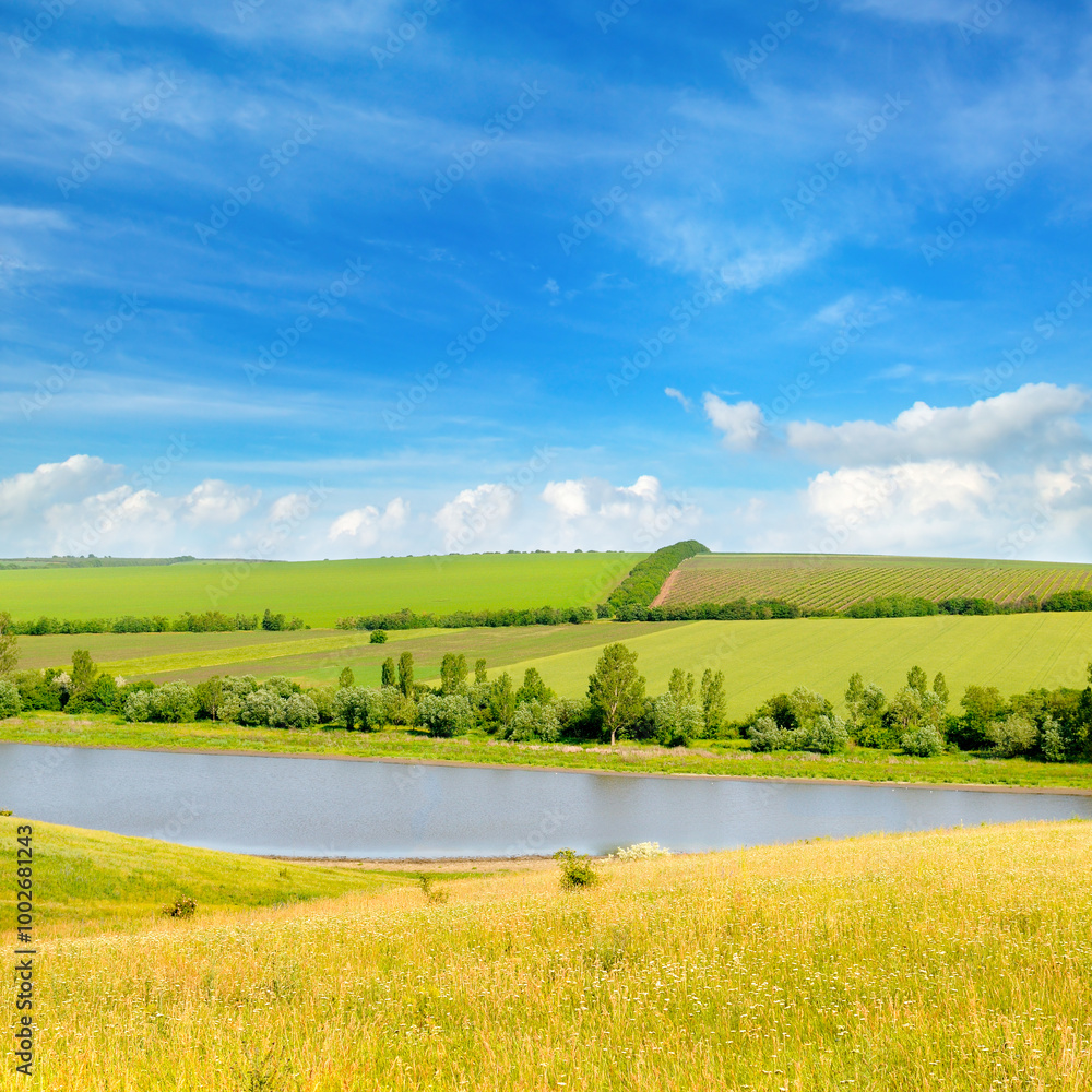 Fototapeta premium Agricultural fields, meadows, lake and sky.