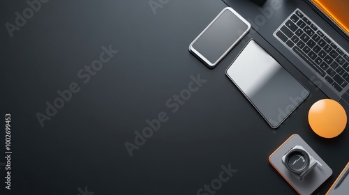 Top-down view of a workspace with illuminated tech gadgets, including a laptop and smartphone, on a black background photo