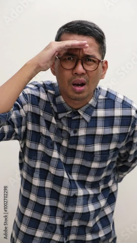 A man looking far away with curious face expression photo