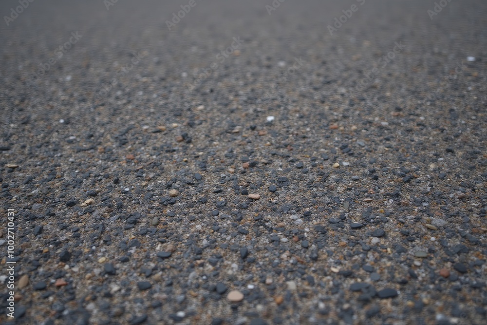 Rough textured asphalt surface with pebbles for background or design. Rough textured asphalt surface with pebbles for background or design.
