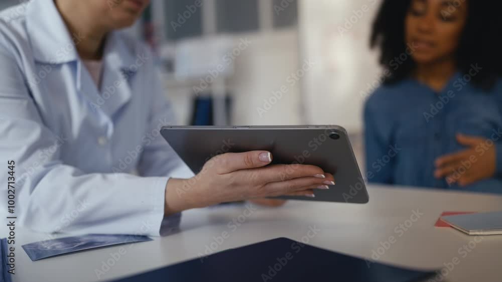 Obstetrician showing fetus ultrasound image to pleased pregnant female patient Obstetrician showing fetus ultrasound image to pleased pregnant female patient