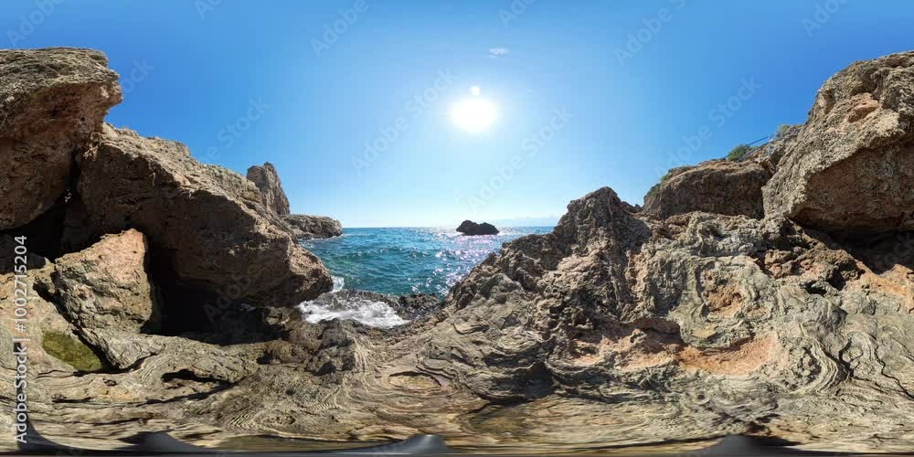 VR 360. Rocky coastal scene in spherical panorama, with a bright sun reflecting off the ocean, highlighting the rough textures of the surrounding cliffs and creating a serene, wide-angle seascape. VR 360. Rocky coastal scene in spherical panorama, with a bright sun reflecting off the ocean, highlighting the rough textures of the surrounding cliffs and creating a serene, wide-angle seascape.