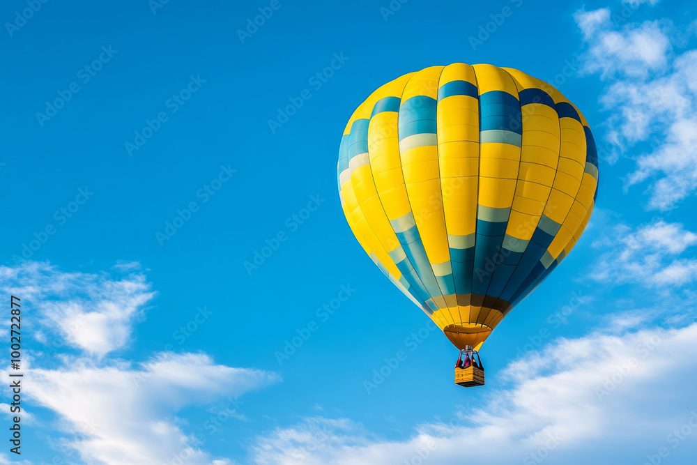 Fototapeta premium Hot air balloon floating in blue sky surrounded by soft clouds