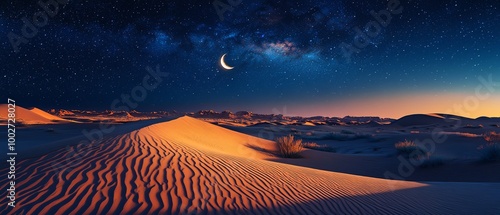 Crescent moon over a desert dune at night.