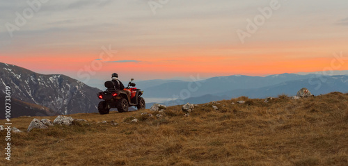 Riding quad bike atv on the mountain top adventure travel.