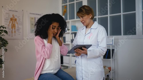 Doctor informing woman patient about breast check-up results, possible disease