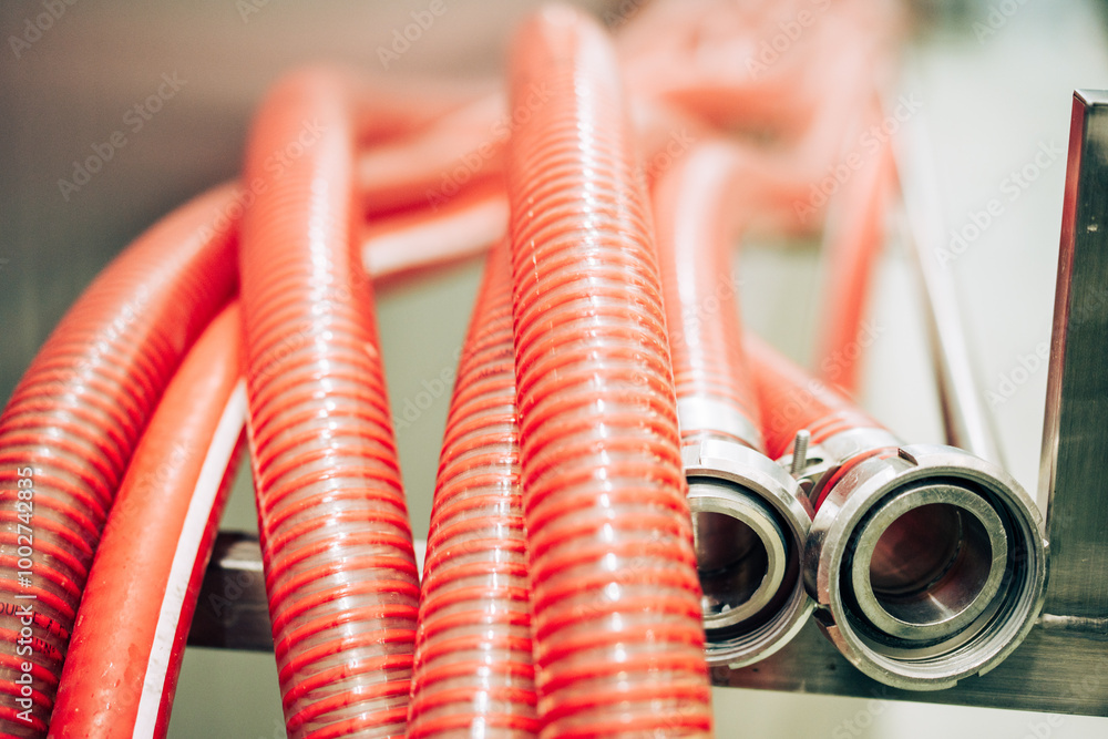 Flexible red hoses with metal nozzles