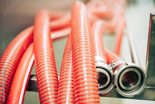 Obraz na płótnie Flexible red hoses with metal nozzles w salonie