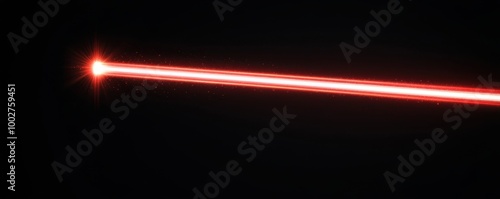 Powerful red laser beam isolated on a dark background.