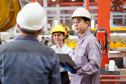 Industrial engineer team works together in factory.