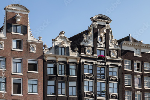 Medieval canal houses with historic facades on the Oudezijds Voorburgwal in the center of Amsterdam. photo