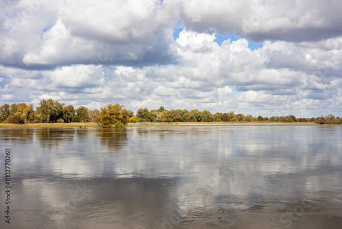 Landscape of the picturesquely spread Odra River on the Polish-German border. Concept. Threat and beauty of nature photo