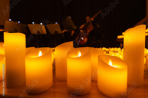 blurred symphonic orchestra on stage with lots of candles photo