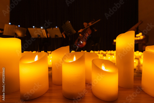 blurred symphonic orchestra on stage with lots of candles photo