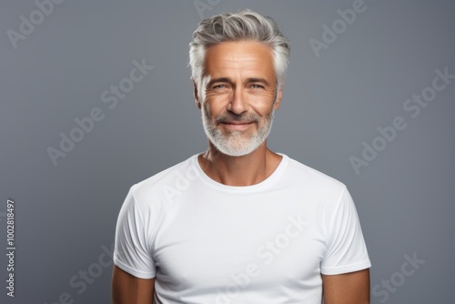 Portrait of a tender man in his 50s dressed in a casual t-shirt in front of plain white digital canvas