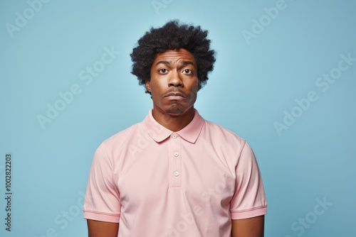 Portrait of a glad afro-american man in his 20s wearing a breathable golf polo isolated in plain white digital canvas