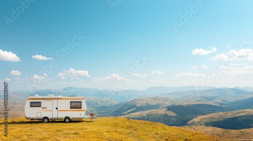 A serene landscape featuring a camper van on a hilltop, with panoramic views of rolling mountains under a clear blue sky.