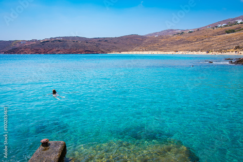 Paralia Agios Sostis wild and free beach in the north of Mykonos, Greece. Pristine bay with blue sea and crystal water, famous for naturism and Kiki's Tavern, peaceful and quiet. photo