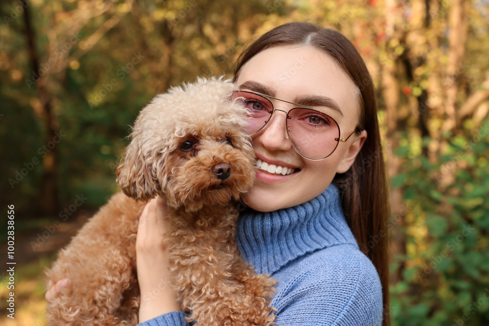 Smiling woman with cute dog in autumn park Smiling woman with cute dog in autumn park