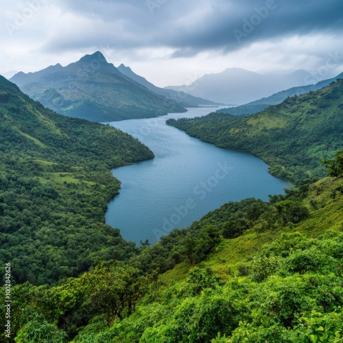 Scenic river landscape surrounded by lush mountains and cloudy sky.