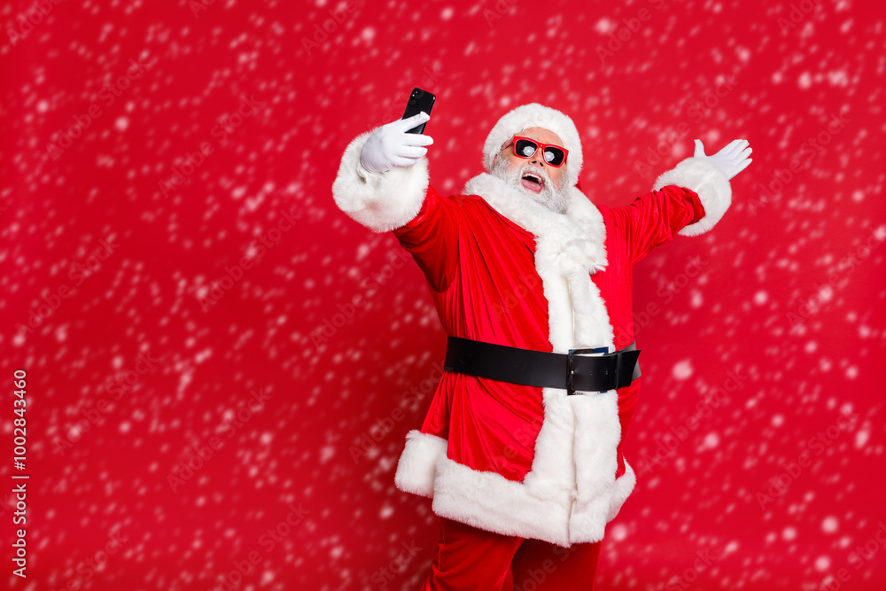 Portrait of his he nice attractive cheerful cheery positive glad friendly hospitable bearded Santa pouted lips taking making selfie blog blogger isolated over bright vivid shine red background Portrait of his he nice attractive cheerful cheery positive glad friendly hospitable bearded Santa pouted lips taking making selfie blog blogger isolated over bright vivid shine red background