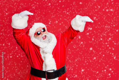 Portrait of his he nice attractive cheerful cheery glad careless bearded Santa having fun rejoicing fairy eve noel celebratory isolated over bright vivid shine red background