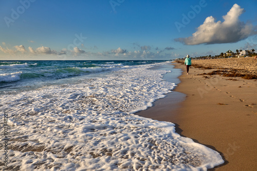 Early walK on a sandy beach finding peace where the ocean meets the sky.  Delray Beach Florida photo