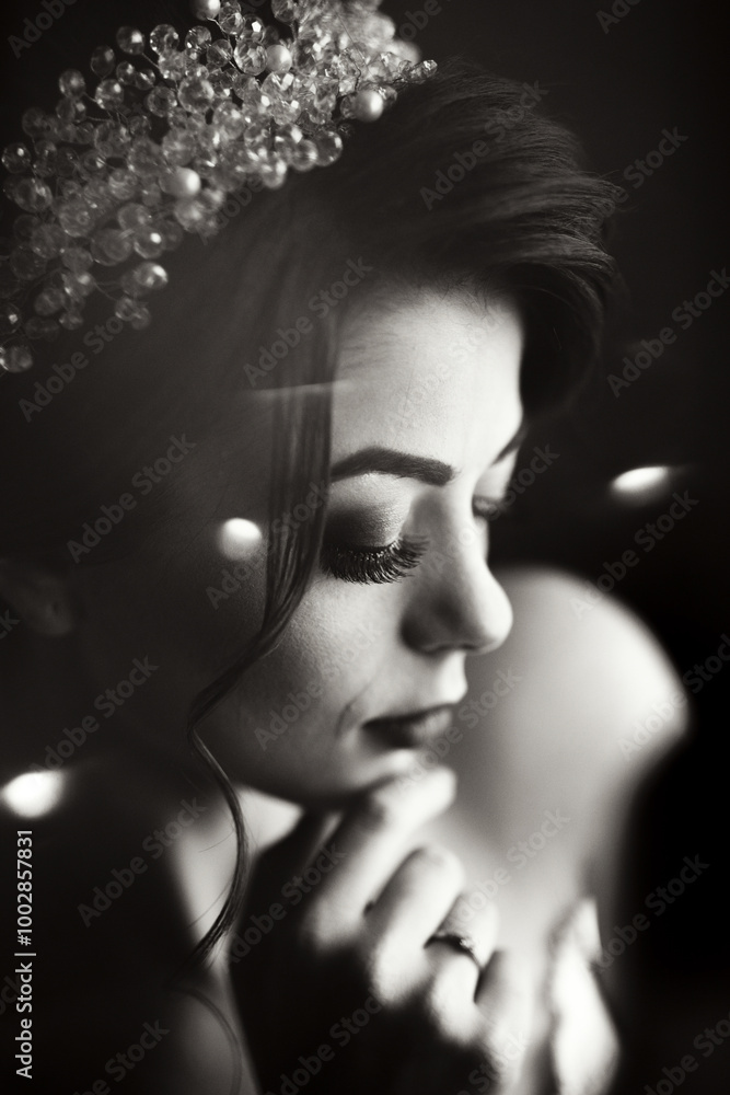 A woman with a pearl headband is looking at the camera. The image has a moody and mysterious feel to it, as the woman's gaze seems to be focused on something beyond the frame. The use of black A woman with a pearl headband is looking at the camera. The image has a moody and mysterious feel to it, as the woman's gaze seems to be focused on something beyond the frame. The use of black