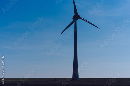Metallic huge windmill proving clean ecological alternative power from nature. Alternative electricity generation