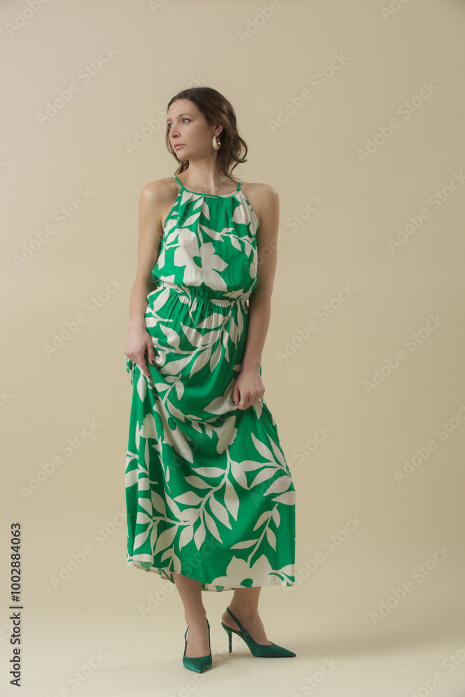 Serie of studio photos of young female model in large floral green linen long camisole dress. Casual and stylish summertime outfit, spring-summer fashion trend. Serie of studio photos of young female model in large floral green linen long camisole dress. Casual and stylish summertime outfit, spring-summer fashion trend.