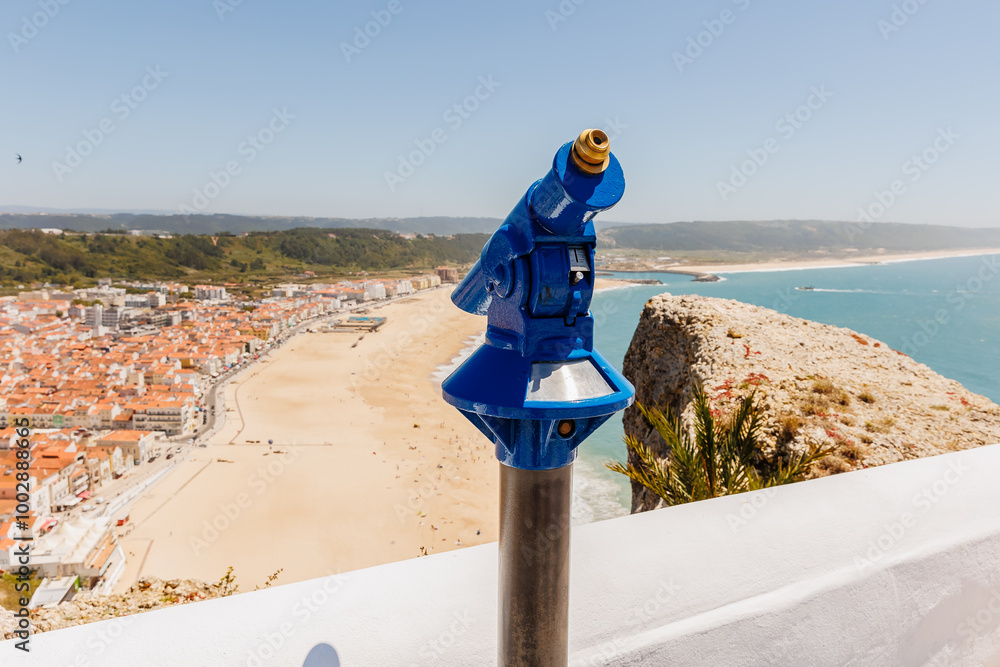 Blue telescope overlooking the bay of Nazare, Portugal