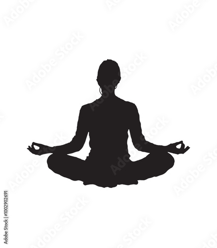 Silhouette of a person sitting cross-legged meditating 
