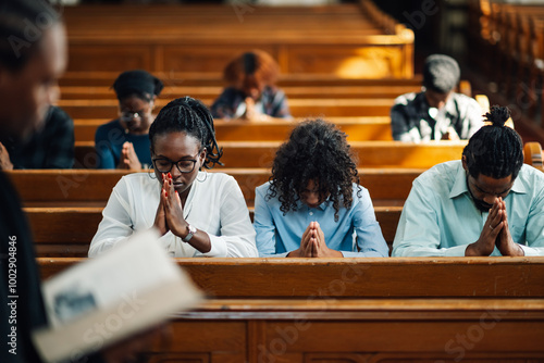 Fotografía Congregation praying in church with priest holding bible