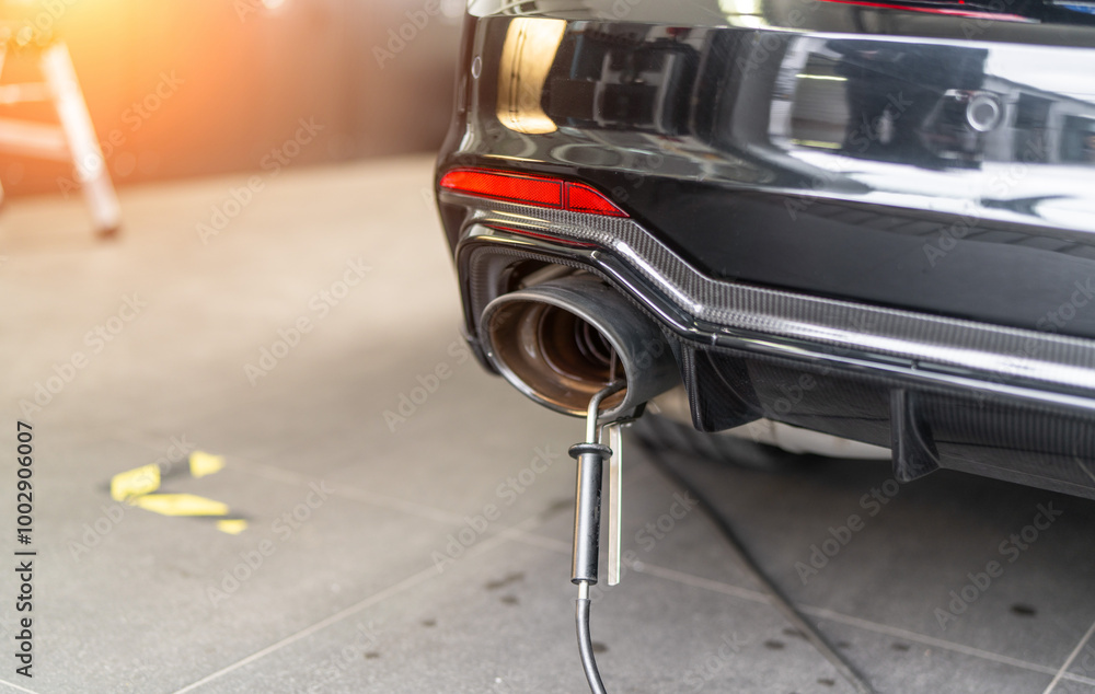 Professional exhaust fume measurement of a modern sports car in a car shop