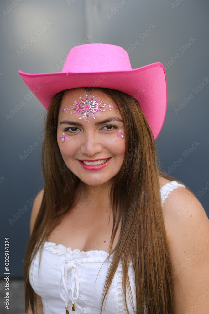 Woman wearing pink cowboy hat and fun rhinestones Woman wearing pink cowboy hat and fun rhinestones