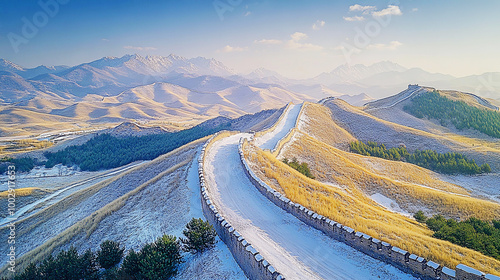 Chinese landscape of valley with antsiest remains of defensive stone made wall, mountains at the background 