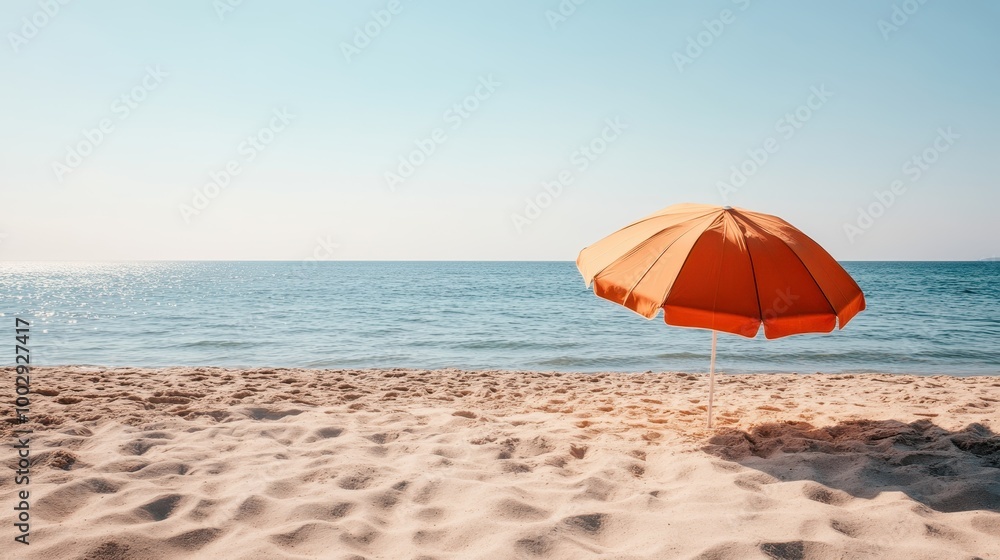 A serene beach scene featuring an orange umbrella in the sand against a clear blue sky, evoking a sense of relaxation and leisurely vacation moments by the sea. A serene beach scene featuring an orange umbrella in the sand against a clear blue sky, evoking a sense of relaxation and leisurely vacation moments by the sea.
