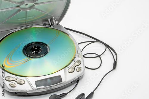Close-up of a discman with the lid open with a CD and headphones isolated on white background