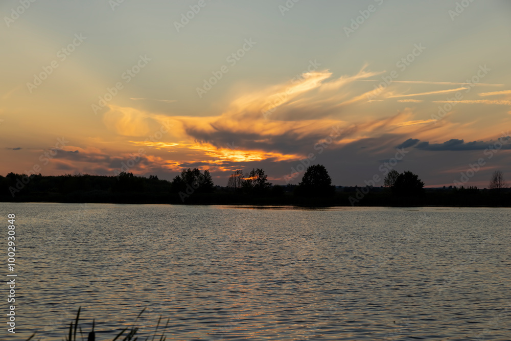 Naklejka premium beautiful bright sunset on the lake in the summer