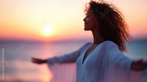 A blissful woman experiences joy and freedom while standing with open arms on the beach during an enchanting sunset, symbolizing liberation and bliss. photo