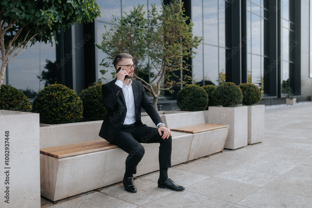 White Collar Worker in Downtown District Talking on Smartphone, Dressed in Suit White Collar Worker in Downtown District Talking on Smartphone, Dressed in Suit