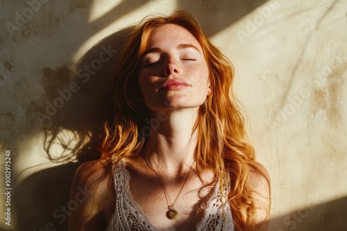 Red hair woman Basking in Sunlight with Eyes Closed enjoying the warmth and serenity of natural light.