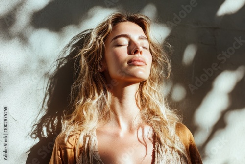 Blonde woman Basking in Sunlight with Eyes Closed enjoying the warmth and serenity of natural light.
