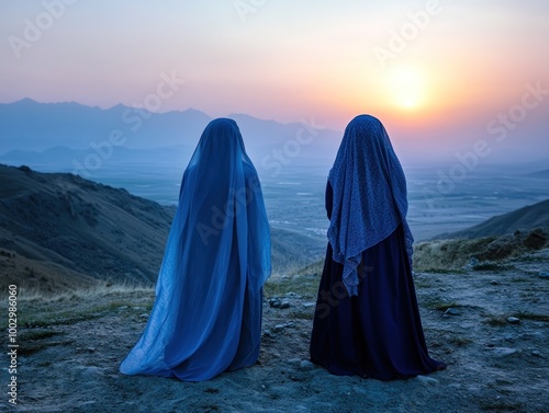 Afghan women in full burkas walking in remote mountain village, AI generated photo