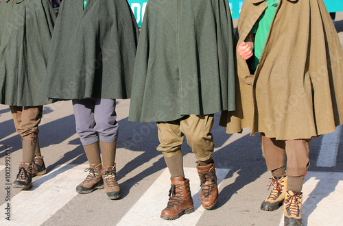 mountain people wearing antique Tabarro cloaks and old boots used during the First World War during a historical reenactment with living characters