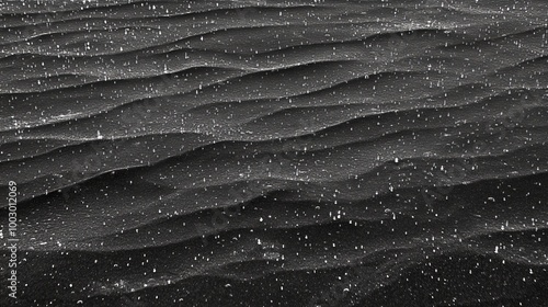 Numerous tiny droplets of rain adorn a smooth, monochrome expanse, forming an intricate and abstract pattern. 