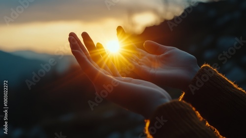 Hands forming a heart shape with the sun shining through during sunset in a n...
