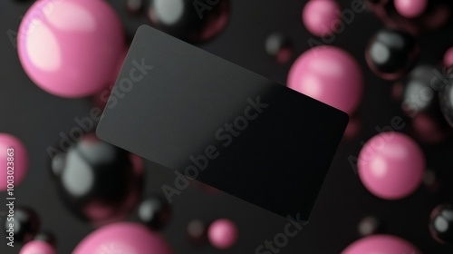 Dynamic display of black and colorful spheres surrounding a card on a pink ba...
