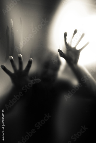 Scary picture of hands behind glass, horror ghost behind door, Halloween concept